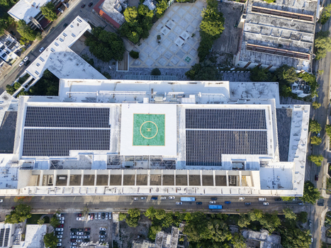 Aerial view of Centro Internacional de Congresos de Yucatan featuring a rooftop helipad and extensive solar panel arrays in the urban landscape of Merida Yucatan Mexico. Aerial view of Centro Internacional de Congresos de Yucatan featuring a rooftop helipad and extensive solar panel arrays in the urban landscape of Merida Yucatan Mexico.
