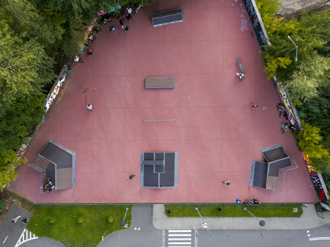 Aerial view of a skatepark with ramps rails and people skating on a red surface in Wieliczka Lesser Poland Voivode Poland.