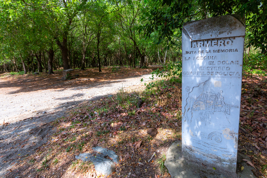View of a stone monument marking the Armero memorial route in a wooded area where the former police station stood in Armero Tolima Colombia.