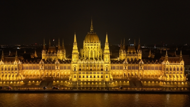 Aerial view of the illuminated Hungarian Parliament Building at night along the Danube River in Budapest Hungary. Aerial view of the illuminated Hungarian Parliament Building at night along the Danube River in Budapest Hungary.