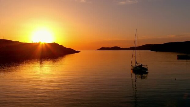 Aerial view of a sailboat at sunset in the Greek islands Greece. Aerial view of a sailboat at sunset in the Greek islands Greece.