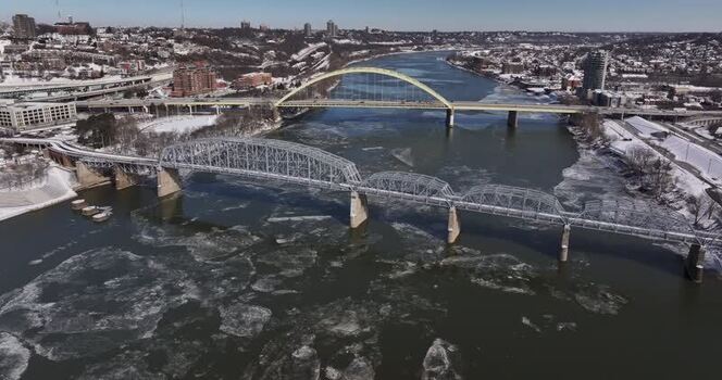 Aerial view of bridges over the icy Ohio River United States. Aerial view of bridges over the icy Ohio River United States.