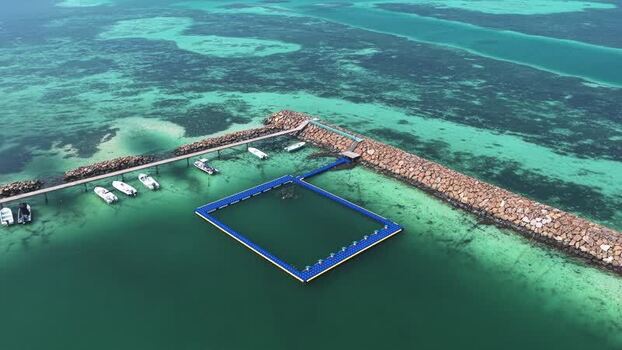 Aerial view of jetty and floating platform in Makunudhoo Maldives. Aerial view of jetty and floating platform in Makunudhoo Maldives.