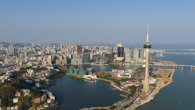 Aerial view of the Macau Tower and the modern city skyline overlooking Nam Van Lake under a clear blue sky in Macau Macao. Aerial view of the Macau Tower and the modern city skyline overlooking Nam Van Lake under a clear blue sky in Macau Macao.