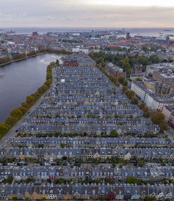 Aerial view of Kartoffelraekkerne historic houses with grey rooftops and green trees by the Sortedam Lake in Copenhagen Denmark. Aerial view of Kartoffelraekkerne historic houses with grey rooftops and green trees by the Sortedam Lake in Copenhagen Denmark.