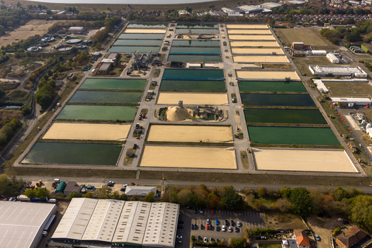 Aerial view of Ashford Common Water Treatment Works with rectangular filtration beds industrial buildings and surrounding greenery in Shepperton England United Kingdom. Aerial view of Ashford Common Water Treatment Works with rectangular filtration beds industrial buildings and surrounding greenery in Shepperton England United Kingdom.