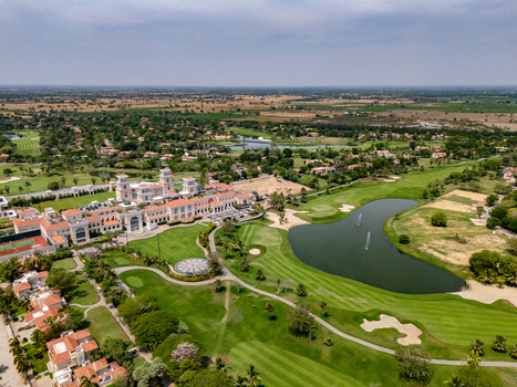 Ahmedabad Gujarat India 21 March 2026 Aerial view of Kalhaar Blues Greens Golf Club with its expansive green fairways water hazards and clubhouse architecture.