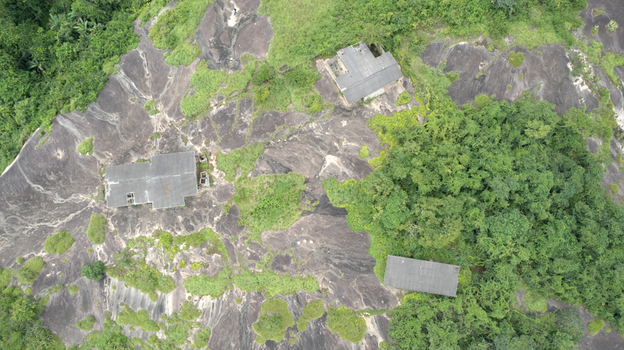Aerial view of Idanre Hill featuring ancient stone structures nestled on rugged rocky outcrops surrounded by lush green vegetation in Idanre Ondo State Nigeria. Aerial view of Idanre Hill featuring ancient stone structures nestled on rugged rocky outcrops surrounded by lush green vegetation in Idanre Ondo State Nigeria.