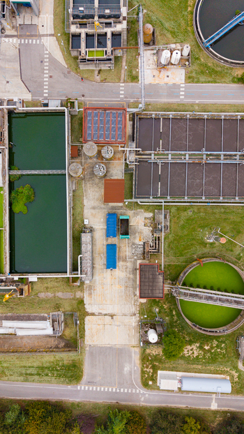 Aerial view of the Depuratore di San Giuliano Milanese Ovest showing industrial water treatment tanks circular sedimentation basins and surrounding green areas in Rancate Lombardia Italy. Aerial view of the Depuratore di San Giuliano Milanese Ovest showing industrial water treatment tanks circular sedimentation basins and surrounding green areas in Rancate Lombardia Italy.