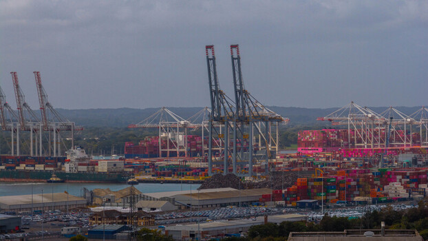Aerial view of the busy Port of Southampton with large container ships towering gantry cranes and stacks of colorful shipping containers in Southampton England United Kingdom. Aerial view of the busy Port of Southampton with large container ships towering gantry cranes and stacks of colorful shipping containers in Southampton England United Kingdom.