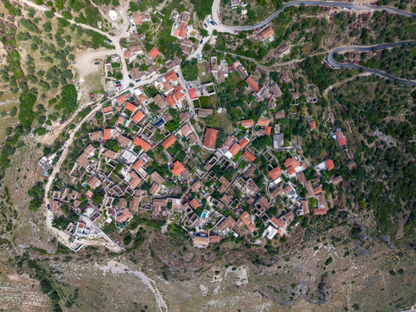 Aerial view of the historic stone houses with red tiled roofs in the hillside village of Qeparo Fshat Vlore County Albania. Aerial view of the historic stone houses with red tiled roofs in the hillside village of Qeparo Fshat Vlore County Albania.