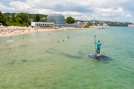 Aerial view of the Neptune statue in the clear turquoise waters of the Black Sea at the beach in Saints Constantine and Helena Varna Bulgaria.