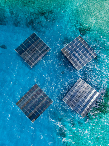 Aerial view of SolarSea floating solar power plant by Swimsol with four square platforms on clear turquoise water Dharavandhoo Baa Atoll Maldives. Aerial view of SolarSea floating solar power plant by Swimsol with four square platforms on clear turquoise water Dharavandhoo Baa Atoll Maldives.