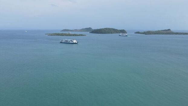 Bakauheni Lampung Indonesia 15 December 2021 Aerial view of ferry boats navigating the calm waters near the islands of Bakauheni showcasing the maritime landscape.