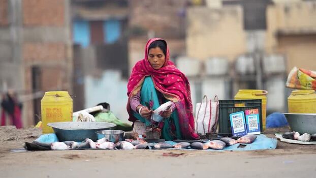 View of a woman selling fish at a street market in Patna India.
