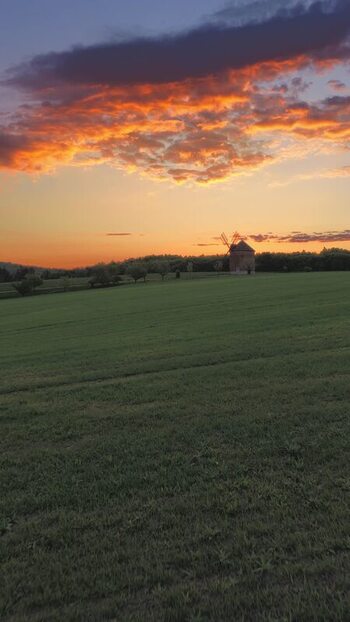 Aerial view of a historic windmill in a green field Czechia. Aerial view of a historic windmill in a green field Czechia.