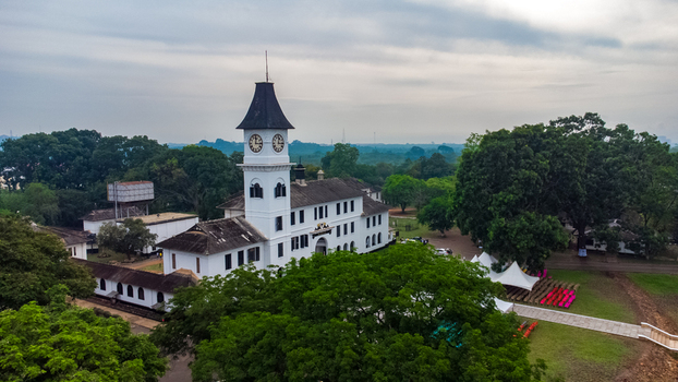Aerial view of Achimota School featuring its iconic white clock tower surrounded by lush green trees and campus grounds in Achimota Greater Accra Region Ghana. Aerial view of Achimota School featuring its iconic white clock tower surrounded by lush green trees and campus grounds in Achimota Greater Accra Region Ghana.