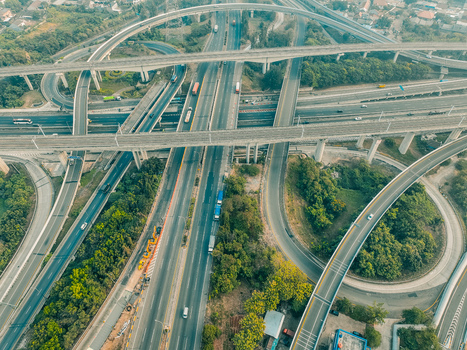 Aerial view of the Cikunir interchange featuring complex multi level highway overpasses surrounded by lush greenery and urban infrastructure in Kecamatan Bekasi Selatan Jawa Barat Indonesia. Aerial view of the Cikunir interchange featuring complex multi level highway overpasses surrounded by lush greenery and urban infrastructure in Kecamatan Bekasi Selatan Jawa Barat Indonesia.