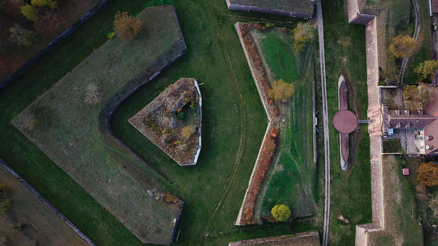 Aerial view of the Vauban walled city of Neuf Brisach with its distinctive star shaped fortifications stone ramparts and autumn trees in Neuf Brisach Grand Est France. Aerial view of the Vauban walled city of Neuf Brisach with its distinctive star shaped fortifications stone ramparts and autumn trees in Neuf Brisach Grand Est France.