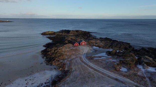 Aerial view of red cabins on the coast of Lofoten Norway.