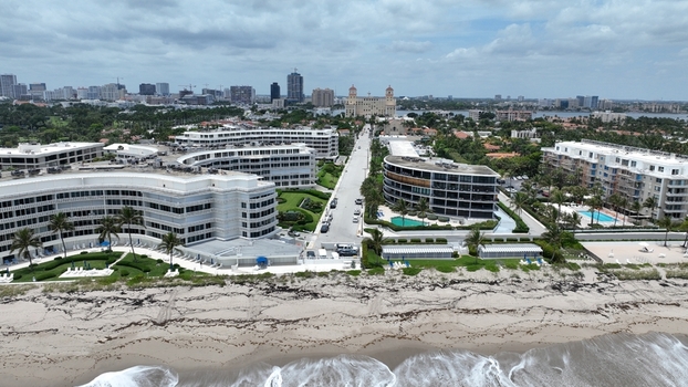 Aerial view of the buildings along the coast and a distant skyline under a cloudy sky Palm Beach Florida United States.