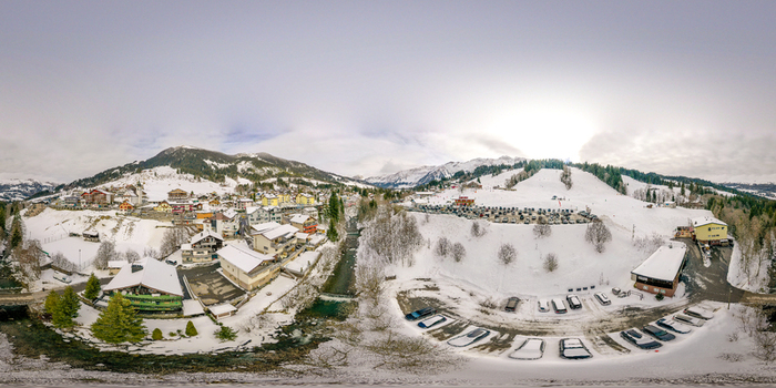 Aerial view of UNESCO Biosphare Entlebuch featuring the snowy village of Soerenberg with mountain peaks and a winding river in Soerenberg Luzern Switzerland. Aerial view of UNESCO Biosphare Entlebuch featuring the snowy village of Soerenberg with mountain peaks and a winding river in Soerenberg Luzern Switzerland.