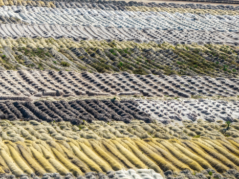 Aerial view of Tagebau Welzow Sud brown coal open pit mine showing textured layers of excavated earth and soil in yellow grey and brown Spremberg Brandenburg Germany. Aerial view of Tagebau Welzow Sud brown coal open pit mine showing textured layers of excavated earth and soil in yellow grey and brown Spremberg Brandenburg Germany.