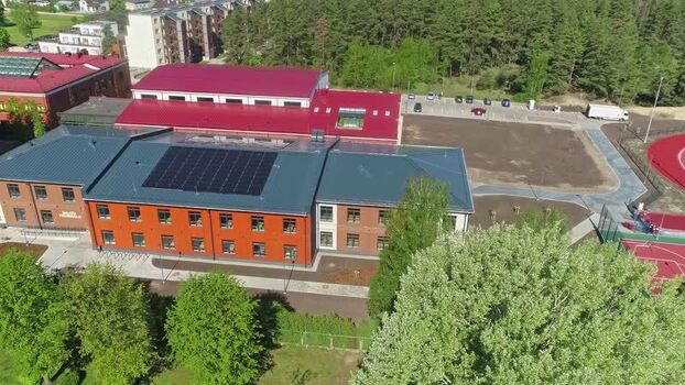 Aerial view of a modern school building in Latvia.