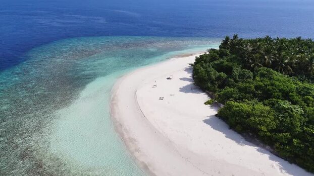 Aerial view of a tropical island with white sand beach Maldives. Aerial view of a tropical island with white sand beach Maldives.