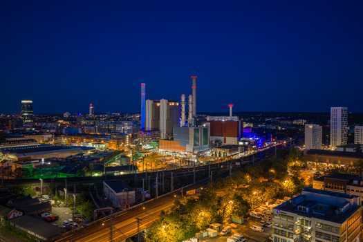 Aerial view of the MAINOVA AG Heizkraftwerk West power plant at night with illuminated chimneys and city lights in Frankfurt am Main Hessen Germany. Aerial view of the MAINOVA AG Heizkraftwerk West power plant at night with illuminated chimneys and city lights in Frankfurt am Main Hessen Germany.
