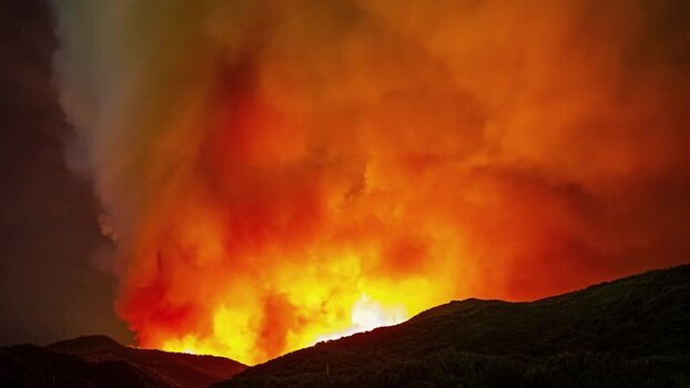View of a massive wildfire burning at night in Spain.
