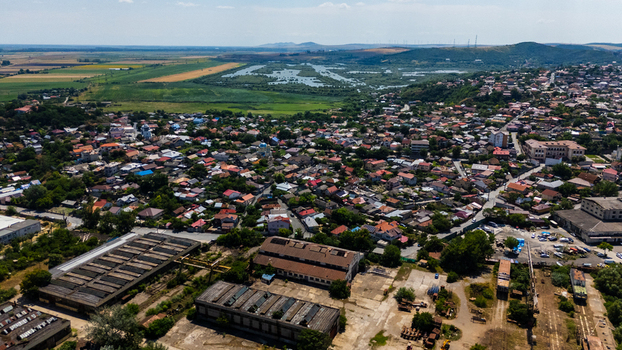 Aerial view of the city of Tulcea with dense residential rooftops industrial warehouses and the expansive Danube Delta wetlands in the background in Tulcea Tulcea Romania. Aerial view of the city of Tulcea with dense residential rooftops industrial warehouses and the expansive Danube Delta wetlands in the background in Tulcea Tulcea Romania.