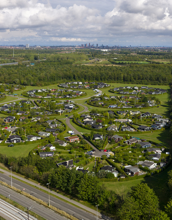 Aerial view of the circular Brondby Haveby garden allotments with small houses and green hedges under a cloudy sky in Brondby Denmark. Aerial view of the circular Brondby Haveby garden allotments with small houses and green hedges under a cloudy sky in Brondby Denmark.