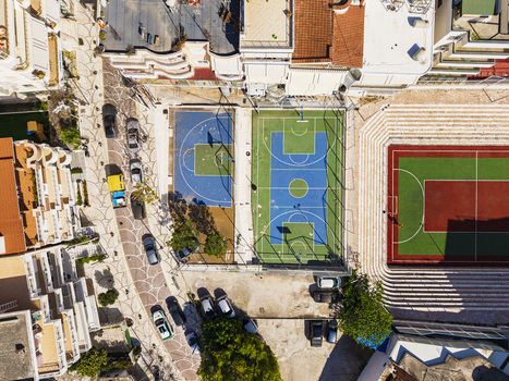 Aerial view of the sports complex featuring basketball and soccer courts surrounded by urban buildings and paved walkways in Saranda Vlore County Albania. Aerial view of the sports complex featuring basketball and soccer courts surrounded by urban buildings and paved walkways in Saranda Vlore County Albania.