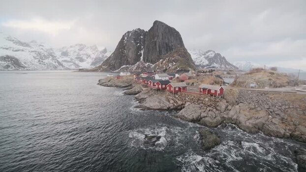 View of Hamn&oslash;y village and snow capped mountains Norway.