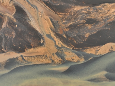 Aerial view of the intricate patterns of a glacial river delta with dark volcanic sand and sediment deposits in Selfoss Sveitarfelagid Arborg Iceland. Aerial view of the intricate patterns of a glacial river delta with dark volcanic sand and sediment deposits in Selfoss Sveitarfelagid Arborg Iceland.