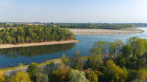 Aerial view of the Po River with low water levels and exposed sandy riverbed sediments due to summer drought Castelvetro Piacentino Emilia Romagna Italy. Aerial view of the Po River with low water levels and exposed sandy riverbed sediments due to summer drought Castelvetro Piacentino Emilia Romagna Italy.