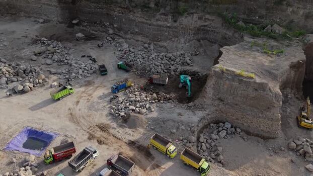 Aerial view of trucks in a quarry in Klaten Indonesia. Aerial view of trucks in a quarry in Klaten Indonesia.