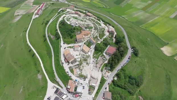 Aerial view of Castelluccio village and green fields Italy.