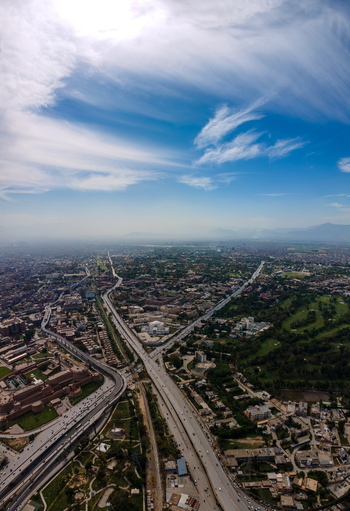 Aerial view of Bala Hisar Fort surrounded by urban sprawl highways and greenery in Peshawar Khyber Pakhtunkhwa Pakistan.
