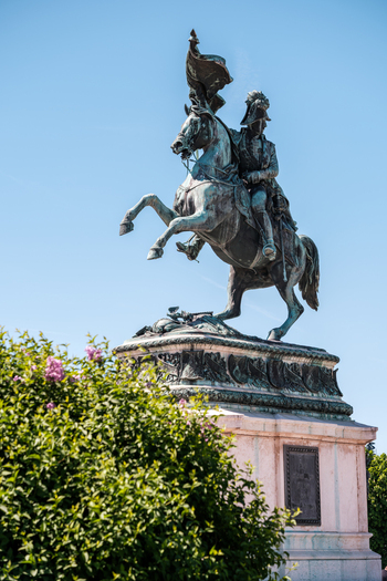 View of the Archduke Charles equestrian statue at Heldenplatz in the Hofburg complex with green bushes and a clear blue sky Vienna Vienna Austria. View of the Archduke Charles equestrian statue at Heldenplatz in the Hofburg complex with green bushes and a clear blue sky Vienna Vienna Austria.