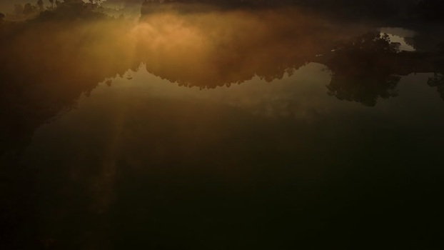 Aerial view of golden mist over the lake in Dieng Plateau Indonesia. Aerial view of golden mist over the lake in Dieng Plateau Indonesia.