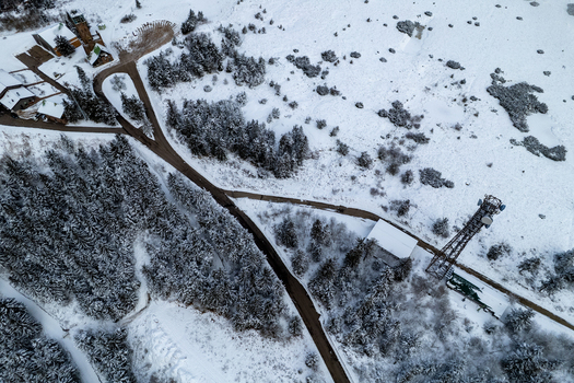Aerial view of Mummelsee in winter with snow covered forest winding roads and a communication tower in Seebach Baden Wurttemberg Germany. Aerial view of Mummelsee in winter with snow covered forest winding roads and a communication tower in Seebach Baden Wurttemberg Germany.