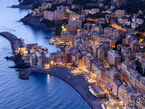 Aerial view of the illuminated historic town of Camogli with its colorful buildings beach and the Basilica di Santa Maria Assunta at dusk along the Mediterranean coast in Camogli Liguria Italy. Aerial view of the illuminated historic town of Camogli with its colorful buildings beach and the Basilica di Santa Maria Assunta at dusk along the Mediterranean coast in Camogli Liguria Italy.