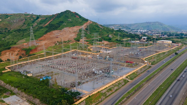 Aerial view of TCN SubStation Katampe with electrical infrastructure power lines and surrounding hills near a highway in Abuja Federal Capital Territory Nigeria.