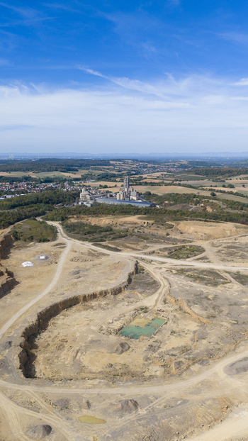 Aerial view of the OPTERRA Wossingen GmbH cement plant and quarry with industrial structures excavation pits and surrounding rural landscape in Walzbachtal Baden Wurttemberg Germany. Aerial view of the OPTERRA Wossingen GmbH cement plant and quarry with industrial structures excavation pits and surrounding rural landscape in Walzbachtal Baden Wurttemberg Germany.
