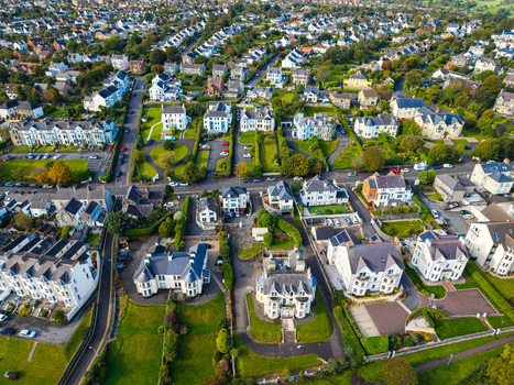 Aerial view of Bangor Harbour and Town featuring dense residential housing historic stone buildings and manicured green spaces Bangor Northern Ireland United Kingdom.
