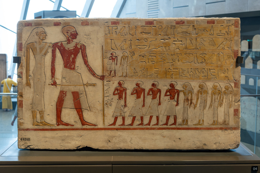 Giza Egypt 16 May 2026 View of an ancient limestone relief with hieroglyphs and painted figures on display at the Grand Egyptian Museum.