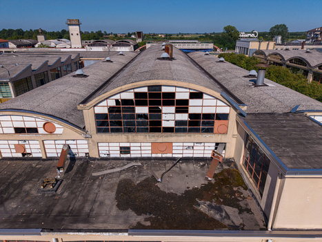 Aerial view of an abandoned industrial factory building with a distinctive arched roof broken windows and weathered surfaces in Casale Monferrato Piedmont Italy. Aerial view of an abandoned industrial factory building with a distinctive arched roof broken windows and weathered surfaces in Casale Monferrato Piedmont Italy.