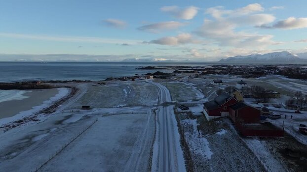 Aerial view of Lofoten coastal road and red houses Norway.